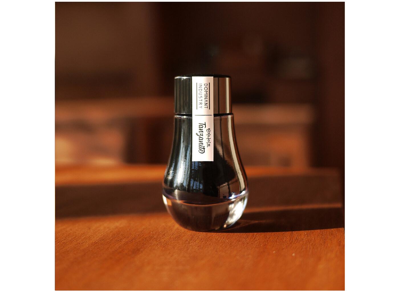 A bottle of Dominant Industry Pearl 018 Tanzanite.