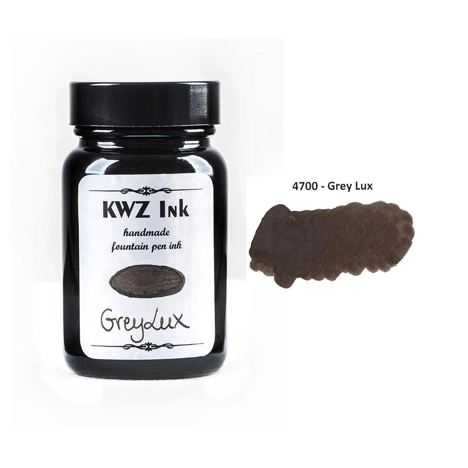 A bottle of KWZ Standard 4700 Grey Lux beside its swatch.