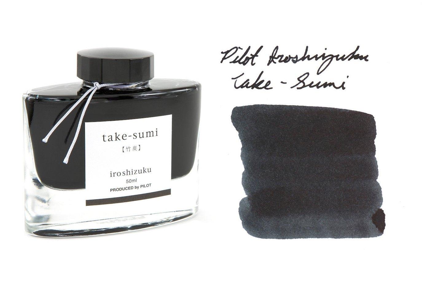 A bottle of Pilot Iroshizuku Take-sumi beside its swatch.